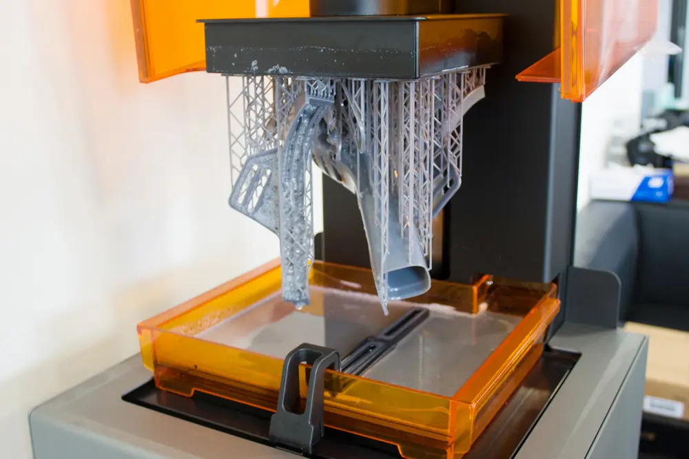 SLA 3D printer creating detailed resin prototype with high-precision layer-by-layer additive manufacturing